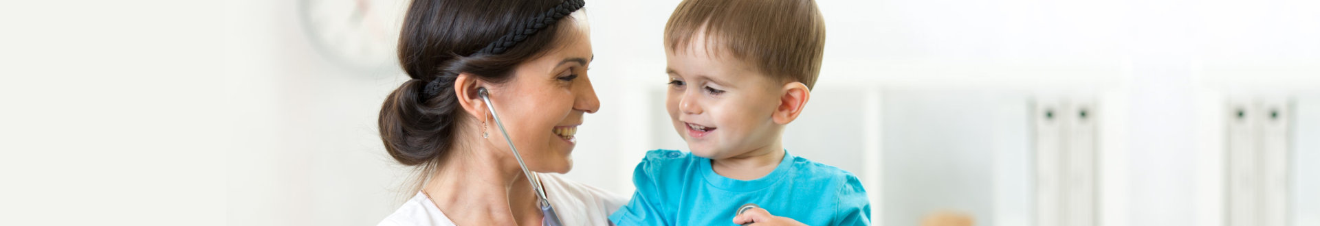 nurse and a child smiling together